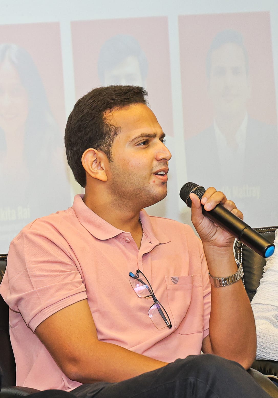 Hardik Mattray speaking with a microphone during a live session